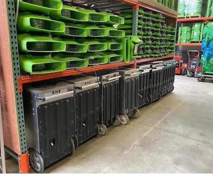 Stacks of ugly gree SERVPRO equipment