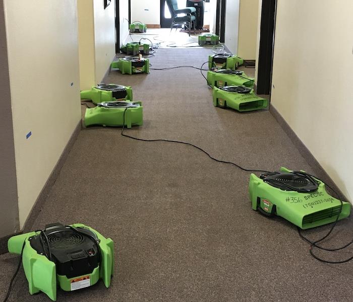SERVPRO air movers on a carpet in a hallway
